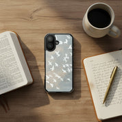 Wings of Peace MagSafe® Christian phone case featuring soft watercolor birds flying across a neutral sky displayed beside an open Bible, coffee mug, and journal on a warm wooden table in a peaceful devotional setting