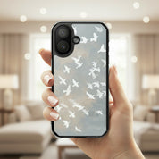 Wings of Peace MagSafe® Christian phone case featuring soft watercolor birds flying across a neutral sky held in hand in a warm minimalist indoor lifestyle setting with elegant peaceful aesthetic